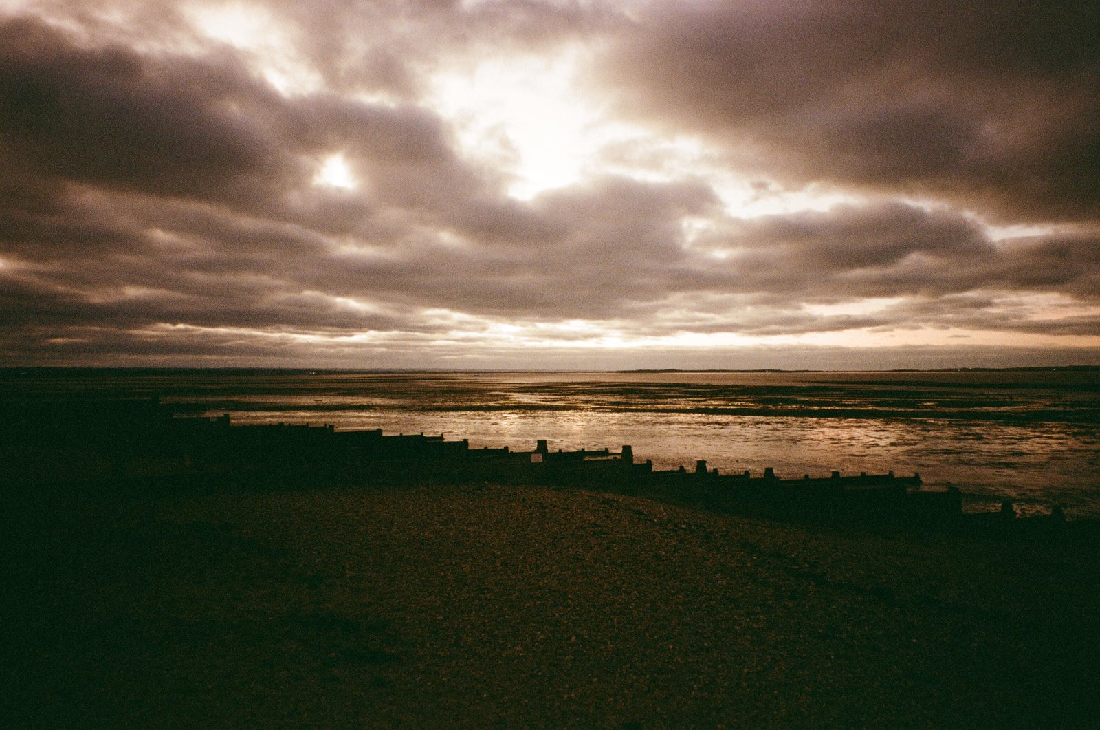 estuary sun through cloud