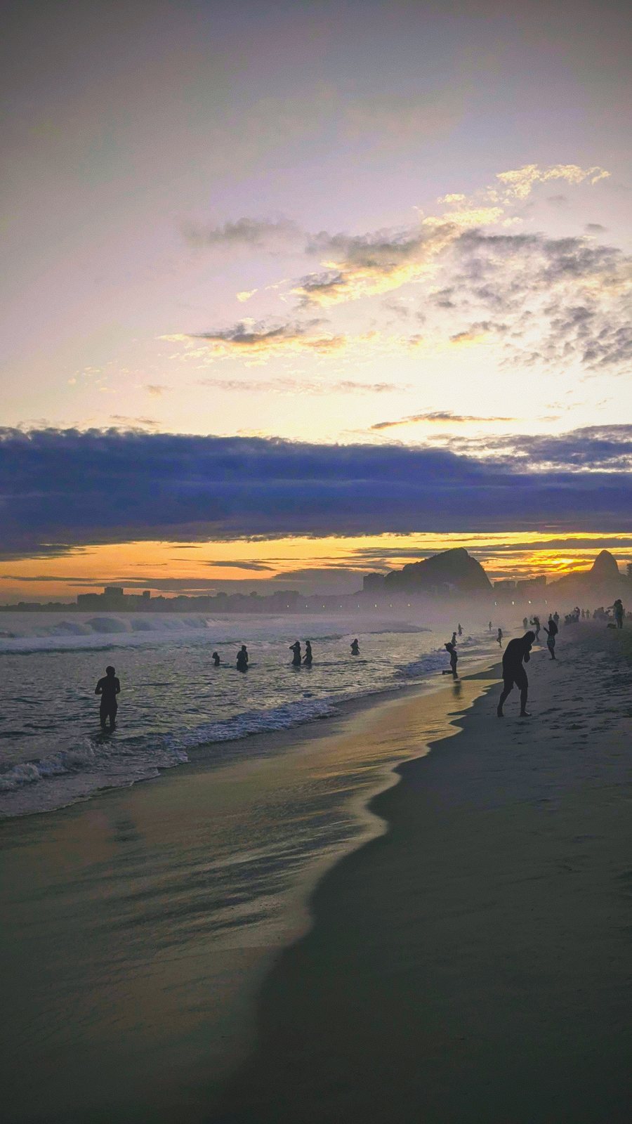 beach dusk figures wet sand